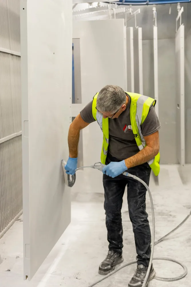 EFS technician applying a door finish in the spray booth